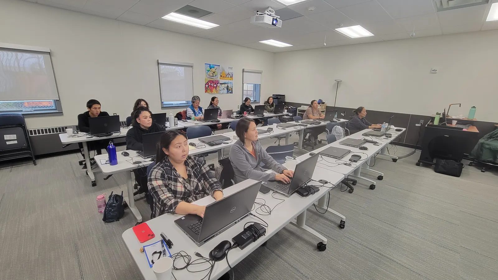 Participants working on laptops during an ANWTC training